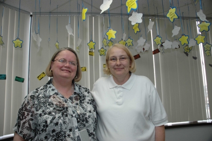 In the Michigan hospital department where Sarah Boik (left) and Deb LeJeune work, staff members hang a star with each co-worker's name on it every time someone does something exceptional. Their office has been studied as an example of a compassionate workplace.