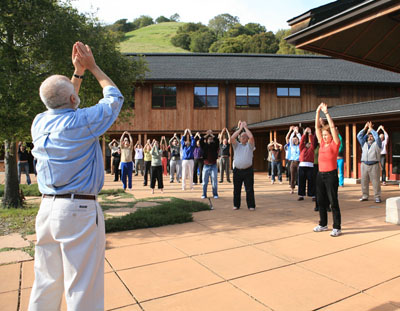 Charles Halpern (left, foreground) leads a Qigong exercise at a retreat for 75 lawyers at the Spirit Rock Meditation Center in California.