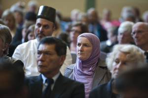The audience at an interfaith event, wearing some religious garb