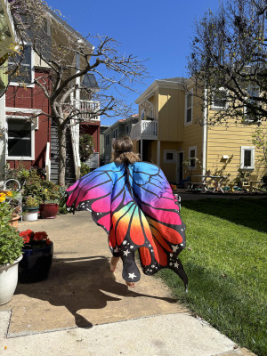 The daughter of author Courtney E. Martin wanders through their cohousing community in a butterfly costume.