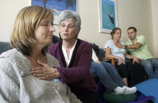 Nancy Bardacke (center) demonstrates a soothing touch on Mary Pearsall, who was participating in Bardacke’s Mindfulness-Based Childbirth and Parenting course.