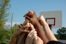 Hands gathering in the air in basketball court
