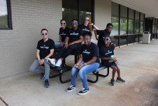 Students in the Empowered program sitting on a picnic table outside