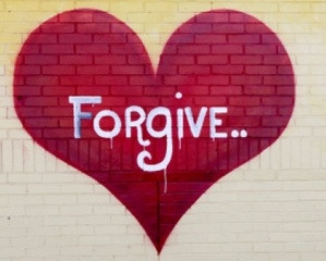 A red heart with the word forgive in the middle
