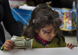 A child buys tickets at the Halloween-Día de los Muertos fundraiser for Junipero Serra Elementary in San Francisco.