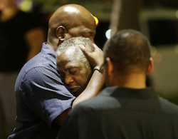 Worshippers embrace following a group prayer across the street from the scene of a shooting Wednesday, June 17, 2015, in Charleston, S.C.