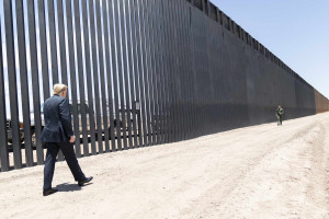 Former President Donald J. Trump walks along the U.S.-Mexico border wall in Arizona in June 2020.