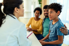 Doctor talking to parents and child