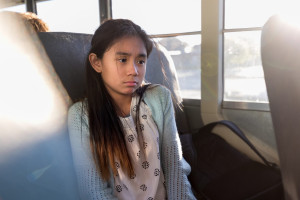 Girl on the bus looking sad and nervous