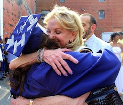 Elaine Wynn, right, chair of the board of directors for Communities In Schools, congratulates Talitha Halley. In the years since Halley fled Katrina, the organization helped her realize her goal of graduating from Howard University.