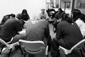 Vinny Ferraro (center, wearing hat) of the <a href=“http://www.mbaproject.org/”>Mind Body Awareness Project</a> leads a workshop at a juvenile hall in the Bay Area.