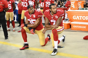Colin Kaepernick #7 and Eric Reid #35 of the San Francisco 49ers kneel in protest during the national anthem prior to playing the Los Angeles Rams in their NFL game at Levi’s Stadium on September 12, 2016 in Santa Clara, California.