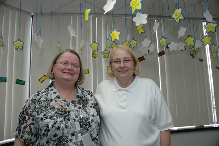 In the Michigan hospital department where Sarah Boik (left) and Deb LeJeune work, staff members hang a star with each co-worker’s name on it every time someone does something exceptional. Their office has been studied as an example of a compassionate workplace.