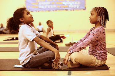 Students engaging in SEL at a program run by the <a href=“http://www.hlfinc.org/programs.htm”>Holistic Life Foundation</a>.