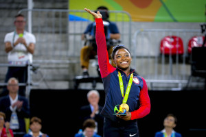Simone Biles wins gold in artistic gymnastics at the Rio 2016 Olympics.