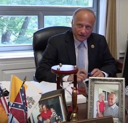Representative Steve King (R-Iowa) with confederate flag, lower left.