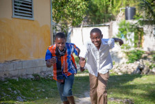 Happy teenage boys running in Jamaica