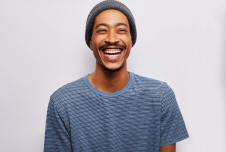 Man with a hat on laughing