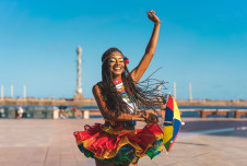 A Brazilian Carnival dancer with colorful clothes and umbrella