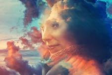 An image of a woman's face blended with colorful clouds, creating a whimsical and dreamlike effect.