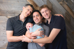 Dr. Ian Jenkins and his partners, Jeremy Hodges and Dr. Alan Mayfield—a polyamorous throuple—made history when they became the first family in California to list three parents on a birth certificate. This month, Jenkins published a book about their journey to parenthood,   <em><a href=“https://cleispress.com/book/2837/three-dads-and-a-baby-adventures-in-modern-parenting/”>Three Dads and a Baby</a></em> (Cleis Press).