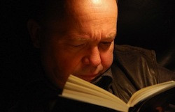 Man intently reading book