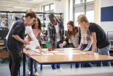 A group of young people working together around a large table