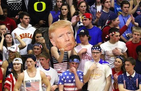 White high school students hold up a picture of Donald Trump and chant “build a wall” during a basketball game against a predominantly Latino school in Indiana.
