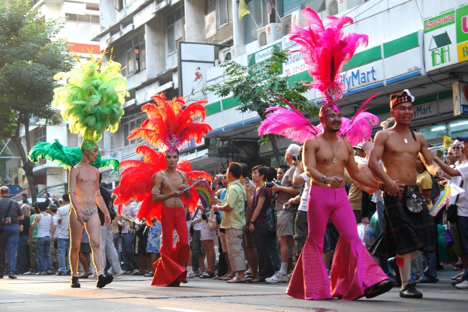 People wearing colorful attire marching in a parade