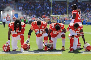 Players for the Kansas City Chiefs take a knee before a game against the L.A. Chargers on Sept. 24, 2017.